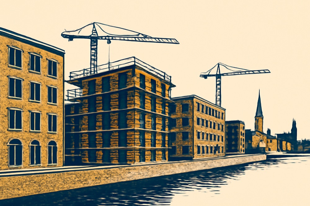 Krane über einem mittelgeschossigen Wohnungsbau an einem deutschen Stadtkai