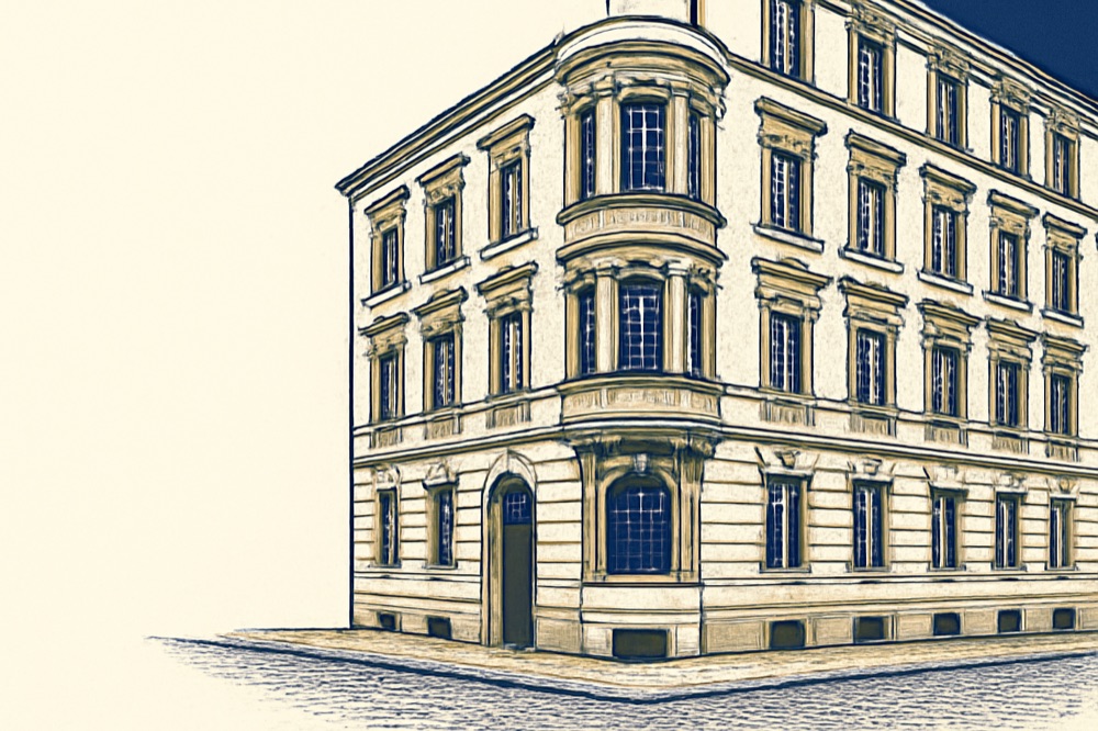 Corner facade of a German pre‑war apartment building on a cobblestone street